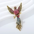 Broche de ave vintage con cristales rosa y verde azulado sobre rama de bronce - Rosa Oro Antiguo