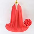 Solid coral red pearl chiffon headscarf elegantly draped on a female mannequin bust - Coral