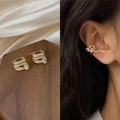 Elegant 14k gold-plated ear cuff with sparkling zircons shown on a model and tray - 30011-Golden Yellow Full Pave Zircon Pair
