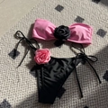 Detailed flat lay of bikini set with 3D fabric roses on bandeau top and side-tie bottoms - S / Pink