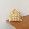 Close-up of yellow plaid linen drawstring bag on a rustic wooden table surface - 14x16cm / Yellow Plaid Small