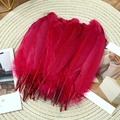 Macro shot of vibrant red goose feathers on a woven mat for DIY craft projects - Stiff Wine Red (50Pcs)