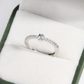 Detail of silver letter K ring with diamonds in a premium green velvet jewelry box - Platinum K