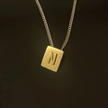 Macro shot of 18K gold plated square pendant with embossed letter N on a fine chain - Pendant Only / Letter N