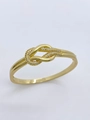 Detail of gold knot bangle featuring row of sparkling inlaid zircon stones on white background - Bangle / Gold