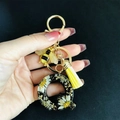 Detail of resin letter Q keychain with real dried flowers, gold bee charm and yellow tassel - Letter Q