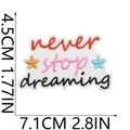Detailed view of Never Stop Dreaming embroidered patch with size markers in cm and inches - No. 23 (Never Stop Dreaming)