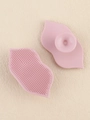 Detailed view of pink lip-shaped silicone exfoliating brush with suction cup handle - Smoky Pink