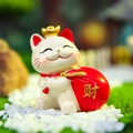Cute white ceramic fortune cat figurine with golden crown and red lucky money bag - Money Bag Lucky Cat