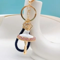 Close-up of ballet girl keychain with pink rhinestones, blue braided rope and golden finish - White + Lanyard