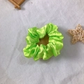 Vibrant bright green satin hair scrunchie with smooth silk texture on linen background - Bright Green