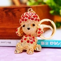 Detailed view of golden metal poodle keychain adorned with sparkling red rhinestones - Poodle Red Rhinestone