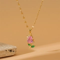 Golden tulip necklace with pink pear-shaped zircon and green leaves on natural stone background - Lips Chain / Gold