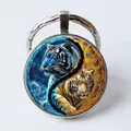 Round metal keychain featuring a blue and orange fire tiger Tai Chi Yin Yang art glass dome - Ice and Fire Tigers/Yin Yang