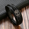 Close-up of black braided leather multi-layer bracelet with metallic skull and magnetic clasp - Black + Matte Black