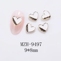 Detail of 9x8mm heart nail charms with sweet engraving on pink manicured nails - Heart Gold White Style (9497)
