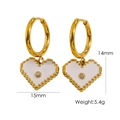 Gold hoop earrings featuring white enamel heart charms with a central zircon accent - White