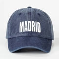 Detailed view of the MADRID printed text on the washed navy blue denim baseball cap - Adjustable / Navy Blue