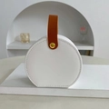 Portable round white jewelry travel case with brown handle and golden button finish - White
