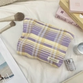 Detail of checkered makeup bag with purple and yellow grid patterns and Sozakka tag - Purple