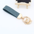 Donkergroene lederen sleutelhanger met ruitpatroon en goudkleurige metalen ringen - Gouden Hardware / Mistblauw