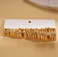 Set van 10 paar gouden geometrische oorringen met gedraaide en gepolijste texturen - Stalen Pin - Milieuvriendelijk Goud (20-delige Set)