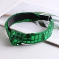 Detailed view of a green sequined knotted headband on a professional white background - Green
