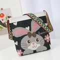 Black and white canvas crossbody bag featuring cartoon bunny embroidery and ethnic strap - Rabbit