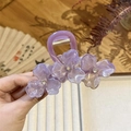 Detail of purple floral hair claw clip with translucent petals and sparkling crystals - Purple