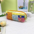 Detailed close-up of a colorful patchwork quilted pouch with a yellow metal zipper detail - Patchwork Small Plaid Flower