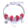 Silver charm bracelet with red glass beads and crown princess pendant on white background - Red