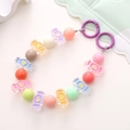 Macro shot of colorful candy-shaped acrylic beads with heart patterns on a phone chain - Colorful Candy Style (K1663)