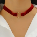 Close-up of deep red velvet choker featuring a polished gold heart pendant on model - Bright Red Velvet Heart Style (X267)