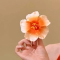 Handheld white to orange gradient hibiscus hair clip with realistic fabric petals - Orange Gradient Hibiscus Hair Clip