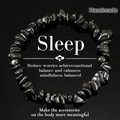 Handmade irregular black hematite stone bracelet with glossy finish on reflective surface - Hematite