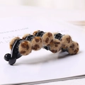 Detail of leopard print plush ball banana clip on an elegant white book background - Light Coffee Leopard Banana Clip