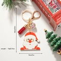 Detail view of Santa Claus keychain with red tassel and snow globe pendant size and weight - Santa Claus