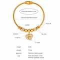 Detail view of gold titanium steel bangle with heart pendant and crystal accents - Pave Heart (Z250) / Gold (Z250)