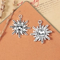 Vintage 25mm silver sun alloy charms on a rustic background for DIY jewelry making - Antique Silver