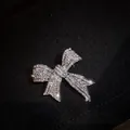 Elegant silver bow brooch with sparkling crystals on dark knitted background - Bowknot Style (X0126)