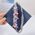 Close-up of handmade mesh flowers and faux pearls on a purple lace headband - Purple Floral