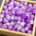 Close-up of 10mm purple cracked glass beads with ice texture inside a wooden box - 34# Jade-Cracked Purple White
