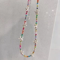 Detailed view of handmade bohemian beaded necklace with white starfish pendants and lobster clasp - Colorful Beads + Off-white Starfish Necklace