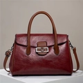 Elegant wine red and brown leather handbag with silver V-shaped buckle and strap - Red
