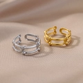 Macro shot of polished 18k gold and silver adjustable rings on luxury satin fabric - Track Bead Hollow