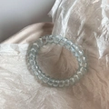 Macro shot of light blue spiral telephone wire hair tie with a translucent finish - Transparent Blue