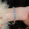 Detailaufnahme vom Silberarmband mit rosa Zirkonia-Blumen und weißen Federn - Pavé-Blütenblatt-Stil (8#)