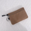 Brown canvas coin purse with black zipper and metal keychain clip for storage - Camel