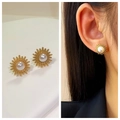 Elegant gold titanium steel sunburst pearl stud earrings shown in a lifestyle model view - 14# Sunflower Pearl