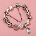 Close-up of silver-plated bracelet with pink rhinestones, enamel flowers and cupcake charms - Sl023318/1216-2